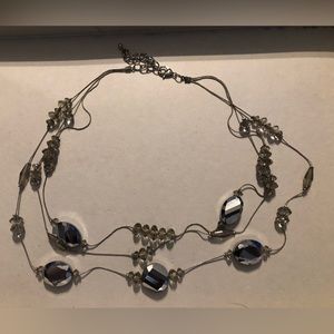 Triple layered beaded silver necklace.